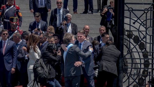 Javier Milei embraces Jair Bolsonaro during his inauguration ceremony outside the National Congress in Buenos Aires on Dec. 10, 2023. 