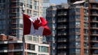 A Canadian flag flies over Granville Island in Vancouver. 