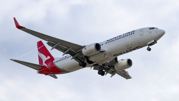 A Boeing Co. 737 aircraft operated by Qantas Airways Ltd. approaches to Sydney Airport in Sydney, Australia, on Tuesday, Feb. 20, 2024. Qantas is scheduled to release earnings results on Feb. 22. Photographer: Brendon Thorne/Bloomberg