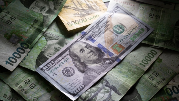 US dollar and South Korean won banknotes.