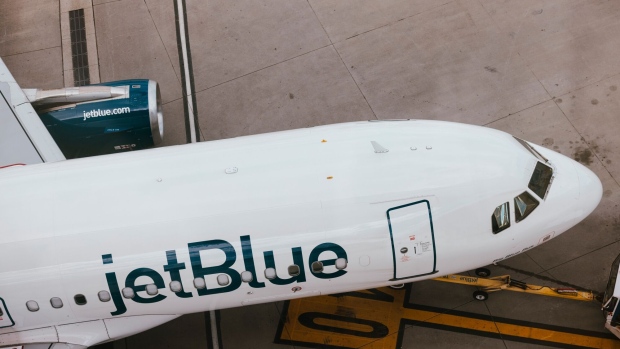 A JetBlue passenger jet at LaGuardia Airport. Photographer: Angus Mordant/Bloomberg