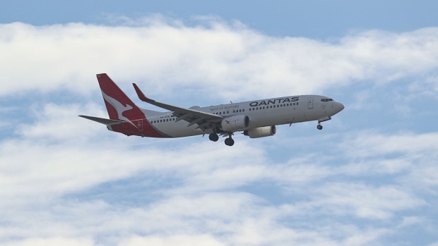 <p>A Qantas Airways aircraft prepares to land at Sydney Airport in Sydney, Australia.</p>