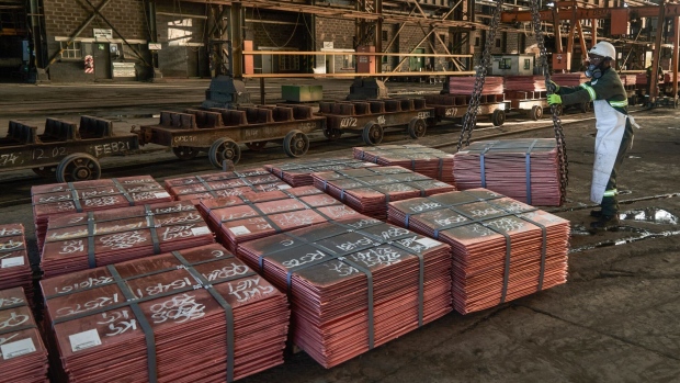 A worker guides stacks of copper plates ready for shipping at the Mufulira refinery, operated by Mopani Copper Mines Plc, in Mufulira, Zambia, on Friday, May 6, 2022. A recent 1,900-mile journey from mines in Congo and Zambia shows how, a century after commercial mining began here, the world’s hunger for copper is again reshaping the region. Photographer: Zinyange Auntony/Bloomberg