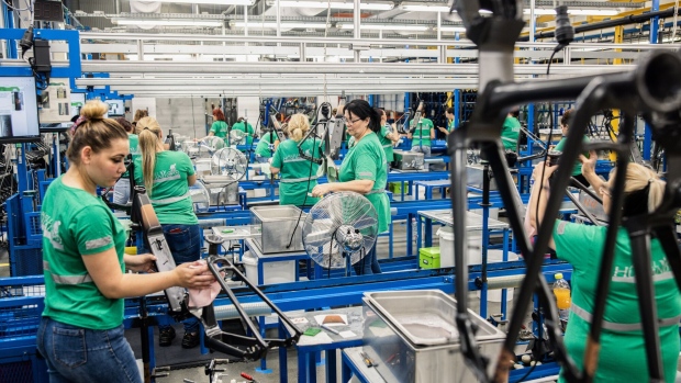Employees work on bicycle frames at a factory in Toszeg, Hungary. Photographer: Akos Stiller/Bloomberg