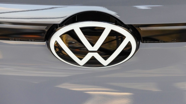 A VW badge on an ID.3 electric vehicle inside of the Autostadt delivery tower at the Volkswagen AG (VW) headquarters and auto plant complex in Wolfsburg, Germany, on Thursday, March 14, 2024. VW wants European regulators to walk back emissions targets that are set to kick in next year and expose Germany’s biggest carmaker to hefty fines. Photographer: Krisztian Bocsi/Bloomberg
