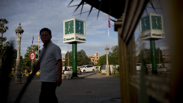 <p>Manulife Financial Corp. signage is displayed on a clock in Battambang, Cambodia.</p>