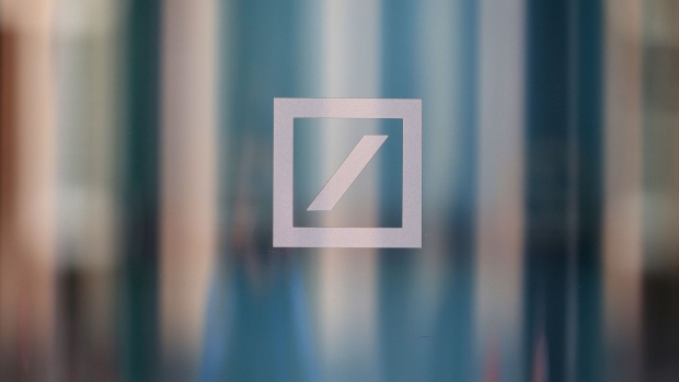A logo in the window of a Deutsche Bank AG bank branch in Berlin, Germany, on Monday, March 27, 2023. Deutsche Bank AG shares rebounded and the cost of insuring its debt against default eased on Monday after sell-side analysts sought to reassure that the German lender’s financial health was sound. Photographer: Krisztian Bocsi/Bloomberg