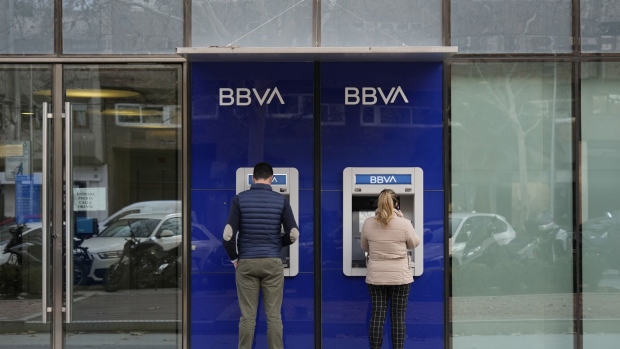 Customers use automated teller machines (ATM) outside a Banco Bilbao Vizcaya Argentaria SA (BBVA) branch in Madrid, Spain, on Monday, Jan. 29, 2024. BBVA report full year earnings on Jan. 30.