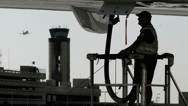 A ground crew worker refuels a plane at Phoenix Sky Harbor International Airport in Arizona.