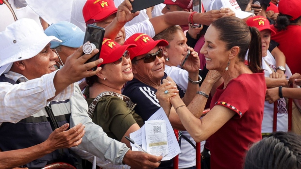 <p>Claudia Sheinbaum greets her supporters during a rally in Puebla, Mexico, on May 25.</p>