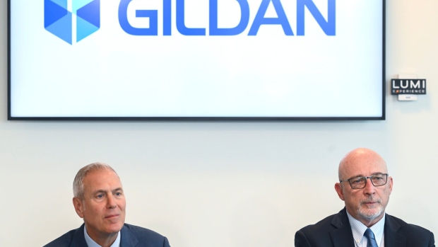 Glenn Chamandy, chief executive officer of Gildan Activewear, left, and Michael Kneeland, chair of Gildan Activewear Inc., listen during a news conference in Montreal on Tuesday.