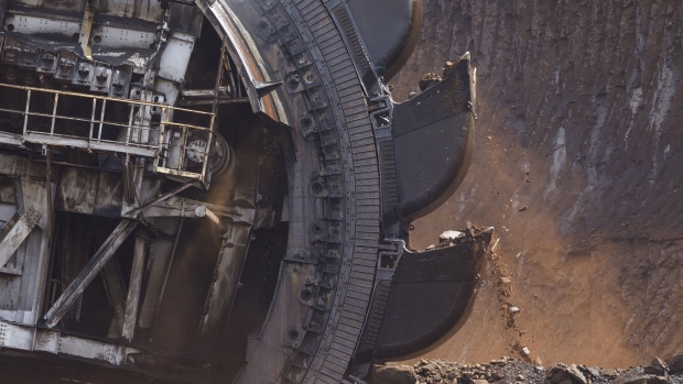 A bucket wheel excavates soil and rocks as a giant excavator operates at an open pit mine. Photographer: Bloomberg Creative Photos/Bloomberg