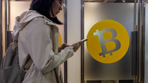 The Bitcoin logo in Hong Kong, China, on Tuesday, Dec. 5, 2023. Bitcoin shrugged off a dip in global stock markets to set another more than 19-month high, a sign of its decoupling from other assets. Photographer: Paul Yeung/Bloomberg