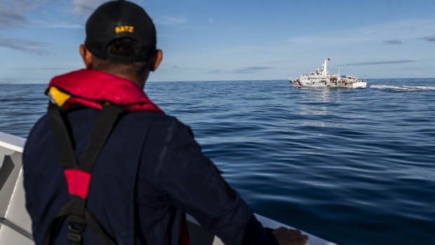 <p>A Philippine Coast Guard personnel looks out at a China Coast Guard ship during a resupply mission for the BRP Sierra Madre, in the Second Thomas Shoal in the disputed South China Sea in 2023.</p>