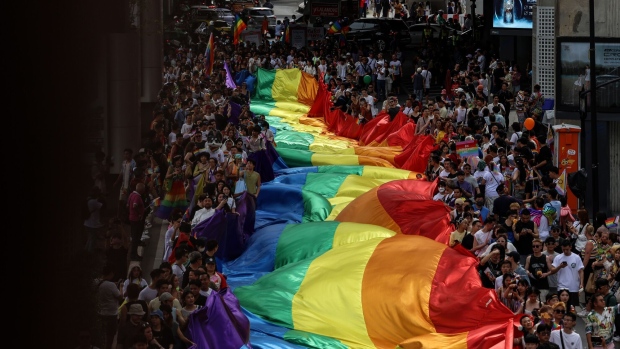 Attendees carry a rainbow flag during the Bangkok Pride Festival 2024 in Bangkok, Thailand, on Saturday, June 1, 2024. Thailand's Senate aims to wrap up a review of a same-sex marriage bill previously cleared by the lower house and put it for a final vote in June, which could make the nation the first in Southeast Asia to guarantee marriage equality. Photographer: Valeria Mongelli/Bloomberg