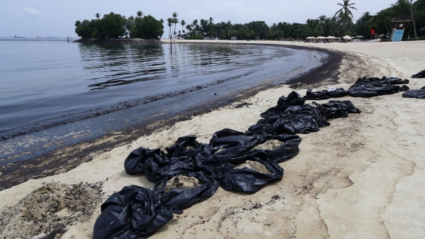 Bags of oil-coated sand along Tanjong Beach on Sentosa Island on June 15.