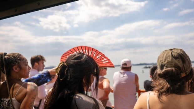 <p>People ride the Staten Island Ferry on a warm afternoon in New York City.</p>