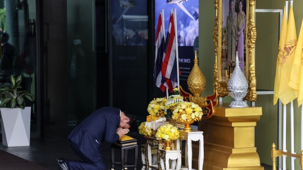 Thaksin Shinawatra bows before a portrait of King Maha Vajiralongkorn after returning from self-exile in Bangkok on Aug. 22, 2023. 