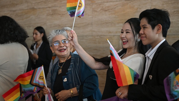 LGBTQ community members arrive at parliament ahead of the final senatorial vote on the same-sex marriage bill, in Bangkok, on June 18. Photographer: Lillian Suwanrumpha/AFP/Getty Images