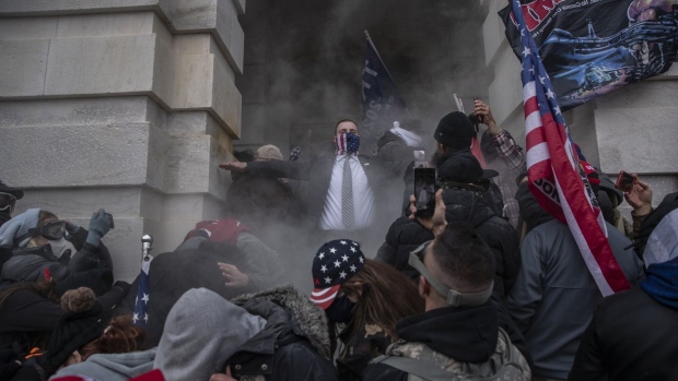 Trump supporters enter the U.S. Capitol building in Washington, D.C. on Jan. 6. Photographer: Victor J. Blue/Bloomberg