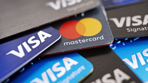 Visa Inc. and Mastercard Inc. credit cards are arranged for a photograph in Tiskilwa, Illinois, U.S., on Tuesday, Sept. 18, 2018. Visa and Mastercard agreed to pay as much as $6.2 billion to end a long-running price-fixing case brought by merchants over card fees, the largest-ever class action settlement of an antitrust case. Photographer: Daniel Acker/Bloomberg