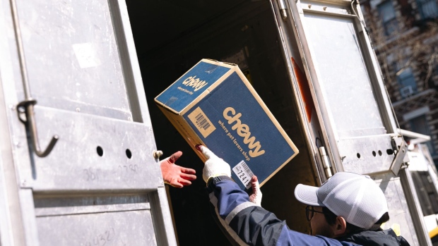 A worker unloads a Chewy shipping box from a Fedex delivery vehicle in New York, US, on Friday, March 1, 2024. Chewy Inc. is scheduled to release earnings figures on March 20.