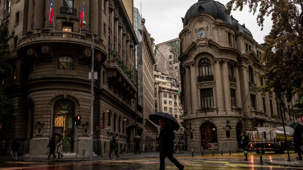 <p>Pedestrians walk past the Santiago Stock Exchange in Santiago.</p>