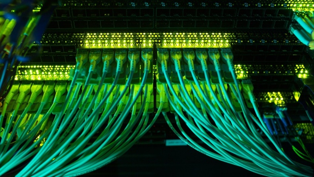 Green lights illuminate cable connected to a server.