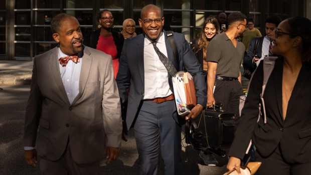 Carlos Watson, center, exits federal court in the Brooklyn borough of New York on June 7.