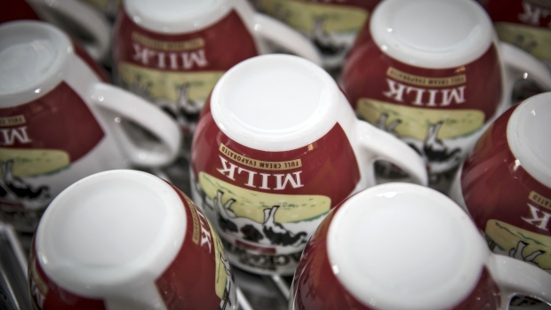Tea cups featuring the logo of Black & White evaporated milk sit on a counter at a Royal FrieslandCampina NV training kitchen in Shanghai, China, on Monday, Feb. 13, 2017. While commonplace in western diets, cream, cheese and butter are seldom used in commercial Chinese kitchens. Dairy exporters are working to change that. Photographer: Qilai Shen/Bloomberg
