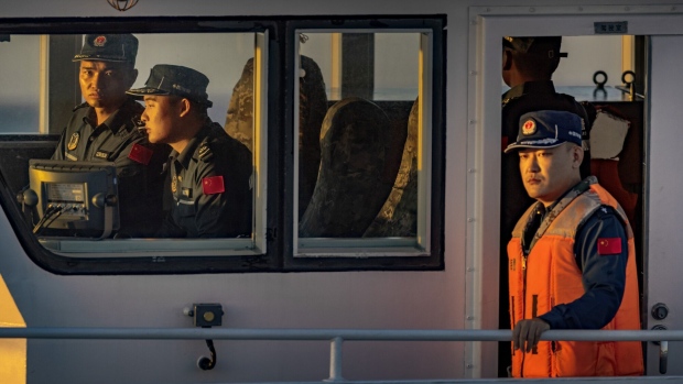 SOUTH CHINA SEA - MARCH 05: Chinese Coast Guard personnel are seen as Philippine ships conduct a resupply mission to troops stationed at Second Thomas Shoal, on March 05, 2024 in the South China Sea. Philippine and Chinese vessels collided in the high seas, leaving four Filipinos with minor injuries after a supply vessel's windshield was shattered by water cannons, the Philippines said. The incidents happened as the Philippines was conducting a routine resupply mission to troops stationed aboard BRP Sierra Madre, a grounded Navy ship that serves as the country's outpost in Second Thomas Shoal (locally called Ayungin Shoal). (Photo by Ezra Acayan/Getty Images)