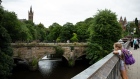 The tower of the Gilbert Scott Building at Glasgow University, left, and the Kelvingrove Museum, from a bridge on the River Kelvin in the West End of Glasgow