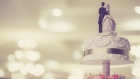 The top of a wedding cake is seen in this file image.